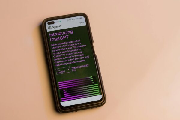 Webpage of ChatGPT, a prototype AI chatbot, is seen on the website of OpenAI, on a smartphone. Examples, capabilities, and limitations are shown.